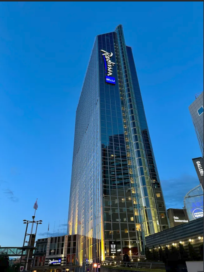Oslo Plaza at dusk, warm lights in the windows.
